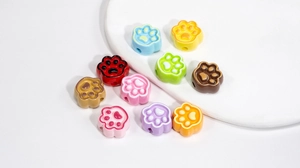 Macro shot of colorful painted cat paw beads with side holes for DIY jewelry