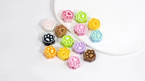 Macro view of colorful cat paw beads in various pastel shades for DIY jewelry making
