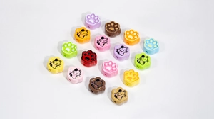 Macro shot of colorful cat paw beads in macaron shades for DIY jewelry making