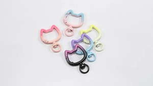 Macro detail of five gradient colored cat head alloy spring clasps for DIY jewelry