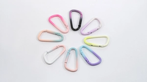 Macro detail of eight colorful gradient D-shaped metal lobster clasps for DIY jewelry