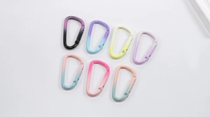Macro view of gradient aluminum D-ring carabiner hooks for DIY keychains and bag charms