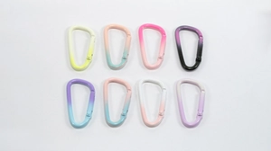 Close-up of eight colorful D-ring carabiners with vibrant gradient spray paint finish