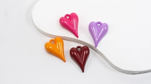Polished heart-shaped DIY charms in four vibrant colors with hanging holes for accessories