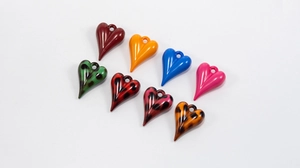 Detailed macro view of colorful leopard print and solid resin heart charms for DIY crafts