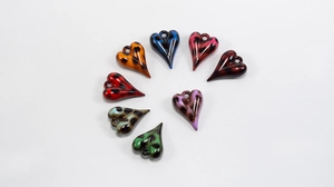 Close-up of eight colorful resin heart charms with black leopard print pattern
