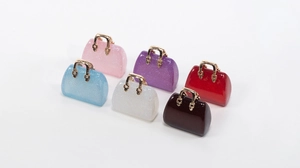 Detailed view of colorful acrylic mini bag pendants with glitter and gold handles