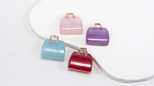 Macro shot of colorful glitter acrylic handbag charms for DIY crafts and jewelry making