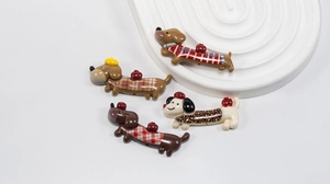 Macro detail of acrylic cartoon dachshund dog charms with patterns for DIY jewelry making