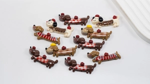 Detailed view of colorful acrylic dachshund charms with leopard and plaid patterns