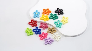 Close-up of colorful hollow flower beads for DIY jewelry making in fifteen vibrant shades