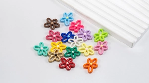 Close-up of colorful candy-colored hollow flower beads for DIY jewelry making accessories