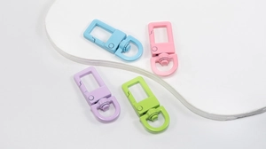 Macro view of colorful macaron metal spring gate buckles and D-rings for DIY crafts