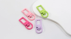Close-up of colorful spring gate rings with rectangular buckles for DIY crafts