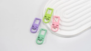 Close-up of matte candy-colored swivel lobster clasps for DIY jewelry and keychain crafts