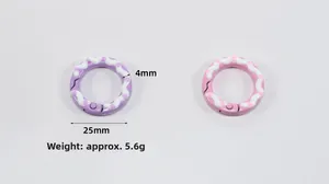 Close-up of 25mm round spring ring buckles with hand-painted polka dots for DIY keychains