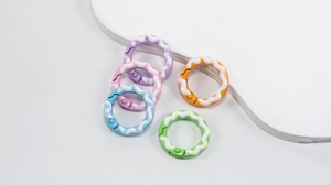 Close-up of five colorful polka dot spring rings with wavy cream coating for DIY crafts