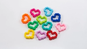 Detailed view of ten colorful pixel heart charms for DIY jewelry and phone chains