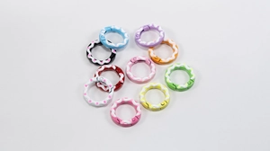 Macro shot of colorful cream-style round spring rings with hand-painted dots for DIY crafts