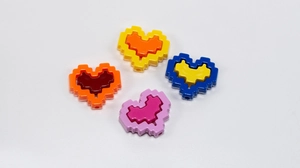 Close-up of colorful pixel heart acrylic beads with pre-drilled holes for DIY jewelry