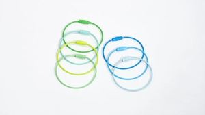 Detail of colorful steel wire keychains showing the secure spiral metal barrel screw locks