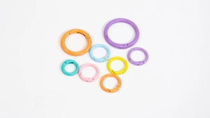 Flat lay of colorful alloy spring O-rings in various sizes for DIY keychains
