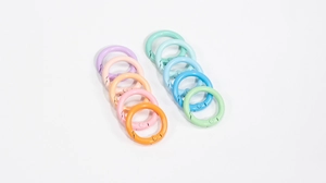 Close-up of colorful round spring snap hooks in mixed candy colors for DIY keychains