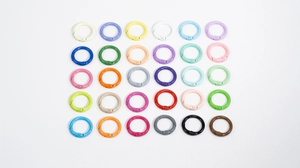 Macro view of 30 colorful round alloy spring ring snap hooks for DIY jewelry and keychains