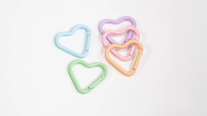 Detailed view of colorful macaron heart-shaped alloy spring gate rings for DIY keychains