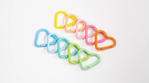 Macro shot of 10 colorful heart-shaped spring ring clasps in assorted macaron colors