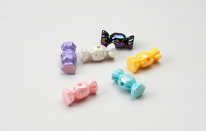 Macro detail of colorful candy-shaped acrylic beads with pearlescent finish for DIY jewelry