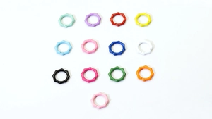 Flat lay of colorful bamboo-textured spring gate rings for DIY keychains and bags