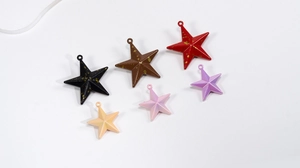 Macro shot of colorful star-shaped pendants for DIY crafts and jewelry making
