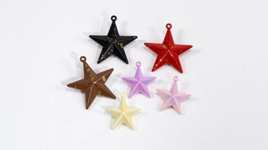 Macro shot of 3D star charms in various colors and textures for DIY jewelry making
