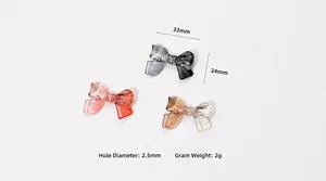 Detail of 33x24mm transparent bow beads for DIY crafts in red, black, and brown colors