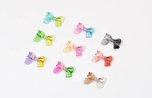 Close-up of translucent resin bow-knot DIY accessories in various gradient color schemes