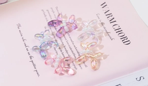Macro shot of colorful iridescent acrylic balloon dog pendants with pearl collars for DIY crafts