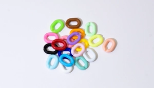 Macro shot of colorful oval acrylic open links for DIY jewelry and bag chain accessories