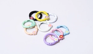 Detailed macro view of colorful zinc alloy floral spring ring buckles for DIY keychains