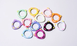 Colorful bear-ear shaped spring rings in various matte finishes and speckled patterns