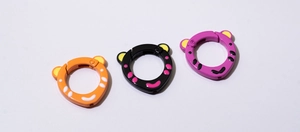 Detail of tiger-style round spring rings in orange, black and purple for DIY keychains