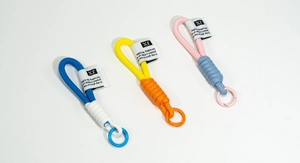 Detail of colorful braided rope keychains with metal snap hooks in high resolution