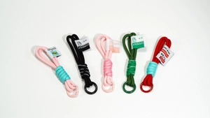 Detail of five colorful braided rope keychains with metal rings and woven labels