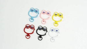 Detailed view of frog-shaped alloy keychains with evil eye beads in six vibrant colors