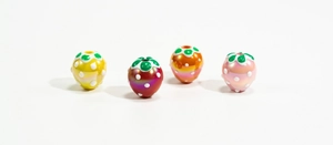 Detail of colorful hand-painted strawberry beads with pearl finish for DIY jewelry making
