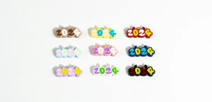 Close-up of colorful 2024 double-sided letter beads with cartoon horns for DIY jewelry