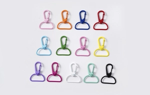 Flat lay view of thirteen colorful alloy swivel lobster clasps for DIY accessories