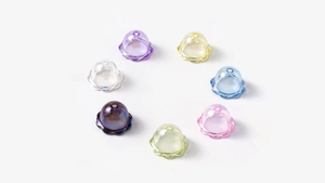 Makroaufnahme von Maiglöckchen-Acrylperlen in bunten Farben mit Loch für DIY-Schmuck