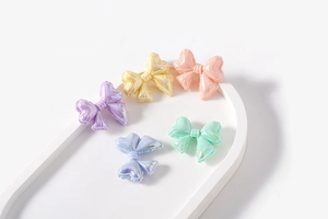 Macro detail of colorful macaron bow beads with a pearlescent finish for DIY jewelry