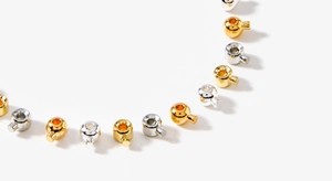 Detailed view of 18K gold and silver plated metal crimp beads for DIY jewelry making